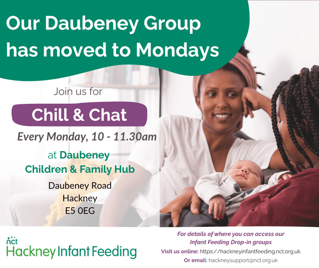 Image shows two people talking with one of them holding an infant.